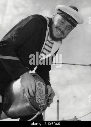 This bearded French sailor grins down on Melbourne as the French Navy training ships Jeanne d'Arc (cruiser, at wharf) and La Grandiere (escort frigate) berth in Melbourne (see right) today. February 16, 1955. Stock Photo