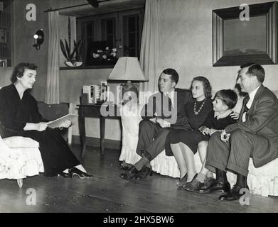 A Family Campaign Conference -- Mrs. Madeleine Sloane, daughter of the late Thomas A. Edison, is shown Sept, 2 in her home at West Orange, N.J., as she read a campaign speech to her family after launching her candidacy for the republican Congressional Nomination form New Jersey's 11th district. Seated opposite her (L to R) Are her son, Thomas Edison Sloane; Mrs. Thomas Edison Sloane; Michael Edison Sloane, Another Son; and John Eyre Sloane, her husband who is a New York investment Banker. March 9, 1938. (Photo by Associated Press Photo).