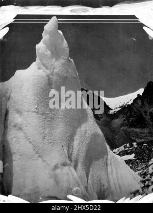 The Mount Everest Expedition An example of one of the wonderful ice formations of Mount Everest's glaciers. The most remarkable scenery in the journey up the glaciers to Everest is the broken ice of the glaciers, forming sometimes pinnacles 300-400 feet high. These pinnacles are made by the cracking of the ice as the glacier twists and turns down the mountain valley leading down from its flanks. The colour of these icy spires is very beautiful - a pale blue when seen at a distance, assuming a green transparent tint close at hand. July 11, 1924. (Photo by The Times Service). Stock Photo