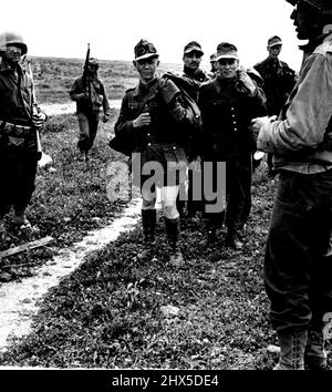 The First Army's Attack on Kairouan. The Americans bring in some prisoners Many of these men were political prisoners in German concentration camps and were released be sent, into the line. Picture taken on the central Tunisien front at the time of the Allied break-through at Fondouk. The main weight of the attack which smashed the enemy hill positions, was bourne by British tanks and British supported by U.S. and French infantry. The Germans were pushed beck wherever they attempted to Make a stand. April 23, 1943. (Photo by British Official Photograph) Stock Photo