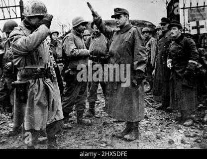 Last Nazi Fortress at Metz Surrenders to U.S. Troops. An American brigadier general (left) of the third U.S. Army salutes as he leaves Fort Jeanne d'Arc, last enemy strongpoint guarding Motz, Eastern France. The assistant commander of the German garrison which surrendered December 13, 1944, gives the Nazi salute as he is taken into captivity with a force of 500. The fortress capitulated 21 days after the city of Metz was liberated. January 31, 1945. (Photo by U.S. Office of War Information Photo). Stock Photo