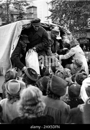 The End of Their War. A woman is hailed aboard a lorry to join her returned husband for the ride home through Berlin. Picture received in London today. There were joyous scenes at Grunewald Station, in the British sector of Berlin, when the first batch of about 600 prisoners-of-war returned home from English prison camps. Women who had waited hours to welcome their menfolk were hysteric with joy at the reunion, and the scene was a mixture of hugs, tears and laughter as the men were dispersed to their homes. October 17, 1946. (Photo by Fox). Stock Photo