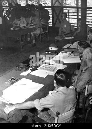 Japanese War Criminal Trials at Darwin - his is the pressmen's view of the courtroom, with members of the court in foreground, a Japanese witness in the witness chair, with interpreter at his side, and the defending counsel and prisoners at rear. Names, from left : Captain W.T. Smith, of Ballarat (Victoria); Member; Lieutenant Colonel Arnold Brown, D.S.O., O.B.E., M.C., President, of Manly (NSW); Major G.J. Ruse, judge advocate, of West Perth (WA); Major D.F. Field, of kew (Victoria) in chair is second Japanese witness, Sergeant Ueda. March 10, 1946. (Photo by Australian Official Photograph). Stock Photo
