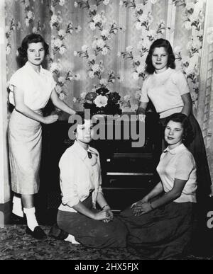 Quads Pose For Birthday Picture -- The Badgett quadruplets are shown above as they posed for their 15th birthday picture here. Thus far the four girls, daughters of Mr. and Mrs. W. Ellis Badgett, have been able to be what they want the most, to be recognized as individuals. They wear different styles of clothes and comb their hair differently. The girls, 15-years-old today, are 9th grade junior high school students. Standing are Jeraldine, left, and Jeanette. Seated are Joan, left, and Joyce. February 1, 1954. (Photo by AP Wirephoto). Stock Photo