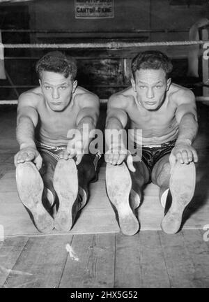 The Young One two -- Heavyweight twins prepare for battle -- Boxers have been known to appear 'in duplicate' to their ***** opponents. But here's double that anybody can see twenty-year-old heavyweight ***** Henry(left) anf George Cooper are pictured at the Tmomas a 'socket Gymnasium, old kent Road, London as they train for Kent professional debut next month. The auburn-haired brothers are to box at ***** on September 14. August 28, 1954. (Photo by Reuterphoto). Stock Photo