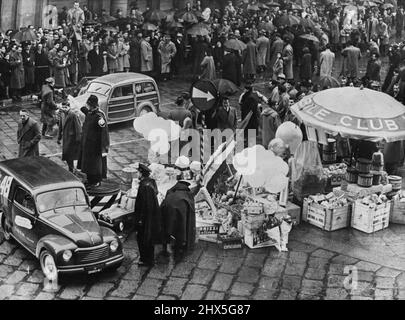 The Police Are Popular Here - The scene in Milan where the pile of gifts for the police made the cross-roads like a market place. In Italy on the feast of Epiphany motorists express their love of the police by placing a gift at the feet of the constable on point duty. January 12, 1953. (Photo by Paul Popper). Stock Photo