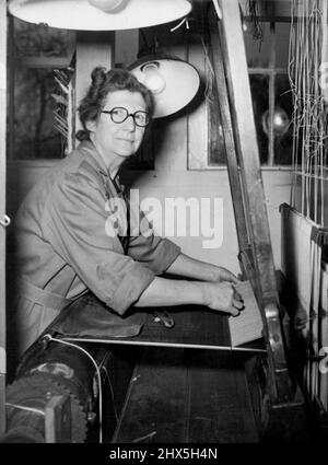 Helps Weave Velvet For Queen's Coronation Robe. Mrs. Hilda Calver at work at Braintree mills to-day. Weavers began to-day (Tuesday) the half-a-yard a day task of making the 20 yards of velvet for the Queen's Coronation robe, at the New Mills of Warner & Sons, Limited, at Braintree, Essex. The velvet, all silk, will be 21 inches wide. It is being woven by Miss Lilly Lee, who wove the Coronation Robe for Queen Elizabeth the Queen Mother, and Mrs. Hilda Carver. November 18, 1952. (Photo by Reuterphoto). Stock Photo