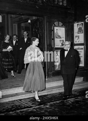 Queen Elizabeth At 'Pajama Game.' Britain's Queen Elizabeth went Tuesday night to see the London version of the smash-hit American musical 'The Pajama Game.' Picture shows the Queen smiling with pleasure as she leaves the theatre at show's end. In background can be seen her consort, the Duke of Edinburgh. November 8, 1955. Stock Photo