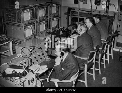 The Nerve Centre For Coronation T.V. The scene in the temporary central main control room with monitor screens, which will record from the various points where television cameras are in operation, The centre screen in the top row (un-named) is for checking the Quality of picture being received by viewers. A temporary main central control for television has been set up in Broadcasting House to deal with the televising of the Coronation. May 28, 1953. (Photo by Fox Photos). Stock Photo