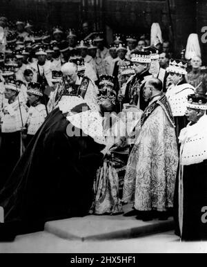 The Queen, wearing St. Edward's Crown and seated on the throne, receives the kiss of homage from her husband, the Duke of Edinburgh, after the crowning ceremony in Westminster Abbey. June 02, 1953. (Photo by Radio Time Hulton Picture Library). Stock Photo