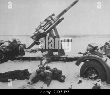 Silent In Death -- Slain members of a German gun crew lie in the snow beside their Anti-Aircraft gun after a Russian attack on the front between Voronezh and Rostov during the recent Red Army offensive. Scene is from official Soviet film. April 12, 1943. (Photo by AP Wirephoto). Stock Photo