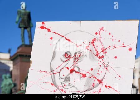 Helsinki, Finland - February 26, 2022: Demonstrator sign portraying President Vladimir Putin as Hitler with blood on his face in a rally against Russi Stock Photo