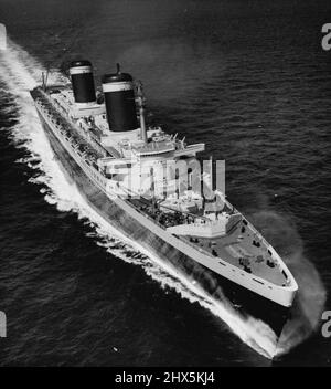 The New Holder Of The Blue Riband -- After her record-breaking crossing of the Atlantic ocean, the 53,300-ton liner 'United States' steams across the English channel to Le Havre, France. This picture was made from the air this morning, July 7, after the vessel, largest ever built in the U.S.A., sailed from the ambrose light outside New York, to Bishop rock, off lands end, Cornwall, in three days, ten hours, 40 minutes, on her maiden voyage. These marks, 2,938 miles apart, are the beginning and end of the blue riband course. July 15, 1952. (Photo by Associated Press Photo). Stock Photo