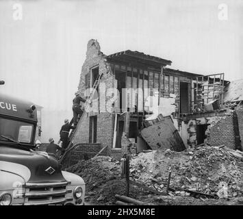 Federal Civil Defense Administration 'Rescue Street' - Rescuers mount a ladder to search for 'casualties' in the 'ruins' of a two-story brick row-house, FCDA Warden and Rescue Training School, Olney, Md. January 21, 1955. Stock Photo