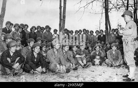 Americans Of Japanese Ancestry Serve In U.S. Army -- A former professional boxer in Hawaii, Sgt. Harry Mijamoto lectures on the use of the hand grenade to members of a special battalion of the U.S. Army made up of American citizens of Japanese ancestry, all former members of the National Guard of Hawaii. The unit, staffed with graduates of the University of Hawaii, has been highly praised for its efficiency and enthusiasm by its commanders. November 01, 1950. (Photo by U.S. Office of War Information). Stock Photo