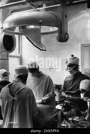 Television Aids The Surgical, Students -- The television cameras above the operating table during the operation at Guys Hospital, London, today. Students of surgery at Guys Hospital, London, can ***** get a close-up view of the skilled hands of a ***** performing the most intricate operations a they sit comfortably around a television screen, and can see every detail. This development in the study of surgery is one of the most important for years. The television camera is poised immediately above the surgeon as he works, and the student sees every movement as he works. May 11, 1949. (Photo by Stock Photo