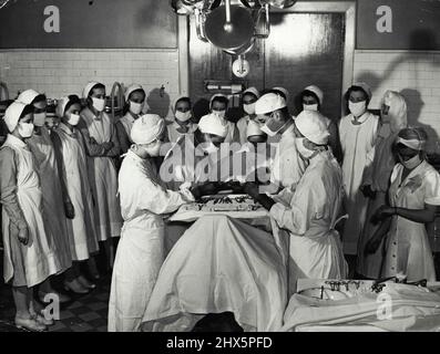 1950s, historical, a nurse on a hospital ward writing up a patient's ...