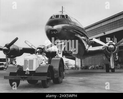 Qantas Aircraft Series. 'Turn Around' complete the Super Constellation is towed from the hangar. October 7, 1955. (Photo by Stuart William MacGladrie/Fairfax Media). Stock Photo