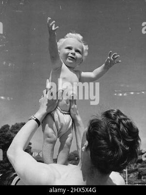 Sunny Boy! - Young Graham Stephenson, of Epping, Essex, aged 12-months, finds it great fun romping about on the beach with daddy, and sings his praises of all this sun and sand which he is enjoying during his first seaside holiday at Felixstowe. First Day At The Seaside - By The Sea. His blonde hair gleaming in the sun, Graham Stephenson, just 12 months old, of Essex (Eng.) bubbles over with excitement on his first day at the beach. August 14, 1947. (Photo by Reuterphoto). Stock Photo