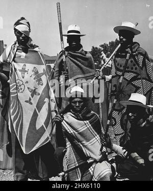 Crime War - A Russian guard at the tunnel that goes under the railwayline dividing them from the Civil Guards. The blanket designs are traditionally Sotho (they are mostly Basutos from Basutoland) and so are the white panama hats and sticks reinforced with colored wire wound round them in gay patterns. October 05, 1952. (Photo by Drum Photo).;Crime War - A Russian guard at the tunnel that goes under the railwayline dividing them from the Civil Guards. The blanket designs are traditionally Sotho Stock Photo