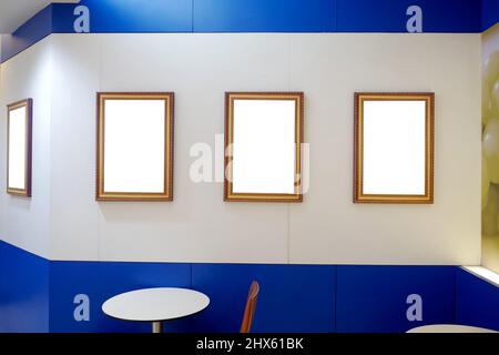 Collection of picture frames for paintings or photographs on the wall. Picture frames on Cement wall. Stock Photo
