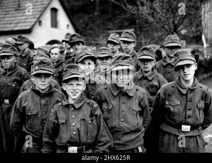 German Boy Soldiers Captured by 11th., Division -- A group of the youngsters in their uniforms. The Americans sent them back to their parents, instead of to a prison camp. When the 11th., Armoured division advanced into the area, of Kronach, they found that all the boys of 15 and get on the road to Bavaria. They were taken by their 22-years-old leader into the woods and there waited the arrival of the Americans to whom they gave themselves up. April 25, 1945.;German Boy Soldiers Captured by 11th Stock Photo