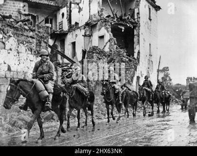 New U.S. Cavalry Advance in Italy: A U.S. cavalry detachment of the Allied Fifth Army passes through a shell-torn Italian town. The mounted men are known as Provisional Mounted Reconnaissance troops and were organized early in the Allied campaign in Italy. They have proved effective in destroying German machine gun nests and artillery emplacements inaccessible to motorized forces. January 10, 1943. (Photo by U.S. Office of War Information Picture). Stock Photo