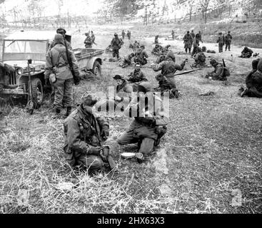 A Day With the 25th (first of ten) - 'Breakfast Nook' for GI's of the 25th division on a cold February morning is an open field. Food was brought up in trailer attached to jeep (left). February 3, 1951. (Photo by ACME). Stock Photo