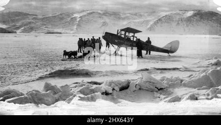 British Arctic Air Route Expedition: An expedition aeroplane on ski on the ice near the Base. In foreground can be seen the rough tide-foot ice, where the sea meets the land. Taken about May 1931. December 28, 1931. (Photo by British Arctic Air Route Expedition Photograph). Stock Photo