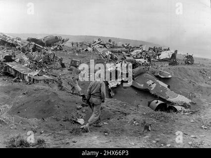 Junkpile Of Wrecked Jap Planes On Iwo -- This Junkpile of wrecked Japanese planes alongside Motoyamo Airstrip No.1 on Iwo Jima represents Havoo wrought by pre-invasion aerial bombings and naval shelling from U.S. forces. This picture was made by Joe Rosenthal Associated Press Staff Photographer on assignment with the wartime still picture pool. March 15, 1945. (Photo by Associated Press Photo). Stock Photo