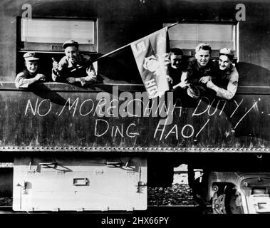 Marines Happy To Quit China -- Members of Fifth Marines smiles from windows of train as they leave Peiping, China, recently, marking end of half a century of U.S. Marine duty in the ancient capital of China. On side of coach is 'No more China Duty! Ding Hao!' Ding Hao is Chinese equivalent of 'That's Great!'. May 26, 1947. (Photo by AP Wirephoto). Stock Photo