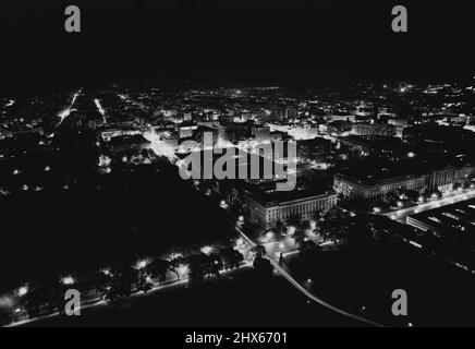 Capital Night Views -- Here is a night view of the city looking Northeast from Washington Monument. The two large buildings at the right are the Labor Department, front and Post Office Dept. rear. Building center foreground is the Commerce Department. The first building, extreme left center is the White House. July 4, 1947. (Photo by Wide World Photos). Stock Photo