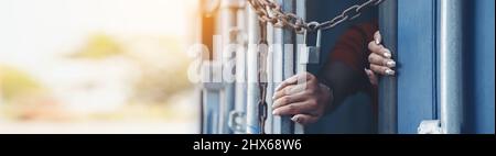 Woman trapped in cargo container wait for Human Trafficking or foreign workers, Woman holding master key wait for holp help Stock Photo