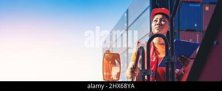 Female Foreman stay on lifting container cargo forklift check or inspect and control forklift concept service and transportation logistic. Stock Photo