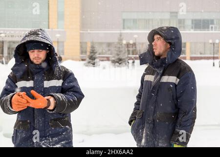 Installers at the construction site are talking Stock Photo