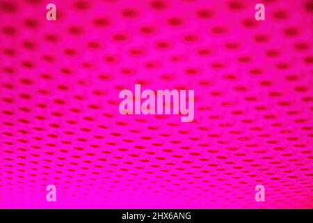 Abstract surface with holes highlighted by pink neon led lights. Abstract backgrounds and textures Stock Photo