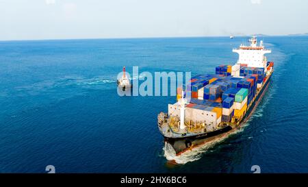 Container ship was dragged by tug boat to international cargo port for service transportation  ,logistic service transportation and maintenance concep Stock Photo