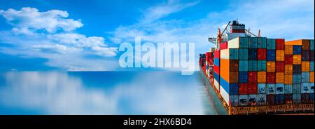Stern of large cargo ship import export container box on the ocean sea on blue sky back ground concept transportation logistic and service to customer Stock Photo