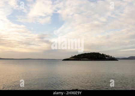 sunlight streaming through clouds reflecting in calm ocean Stock Photo