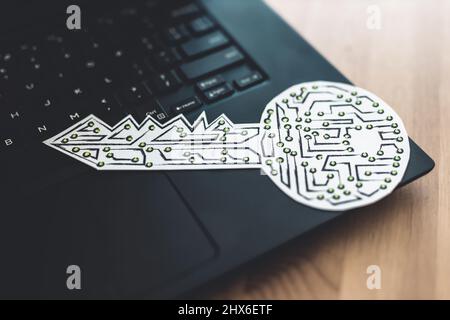 encryption key icon made of circuits and LED lights on top of laptop keyboard, concept of digital security or data encryption Stock Photo