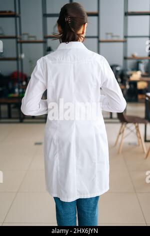 Unrecognizable female doctor posing confident in white medical uniform ...