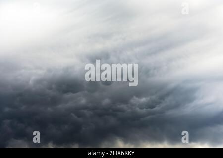 Mammatus clouds fill the sky after a passing supercell thunderstorm Stock Photo