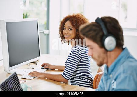 Weve got a great office vibe. Cropped shot of two colleagues working in their office. Stock Photo