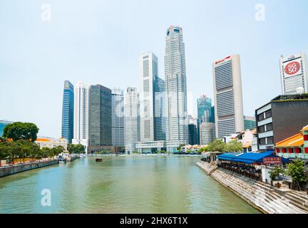 Singapore - August 15 2015;Singapore River and Haven Lobster Seafood restaurant and commercial high-rise buildings beyond River Walk at Boat Quay. Stock Photo