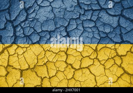 Ukrainian national flag pattern cracked earth, war concept. Stock Photo