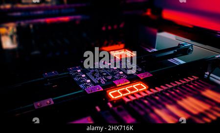 Automated production of computer system boards by Pick and Place robot. Robot Manipulators for assembling computer chips and system computer boards place electronic components on board for fixing. Stock Photo