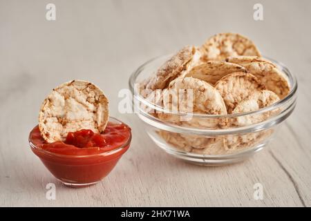 Rice nachos and salsa sauce on a wooden board Stock Photo