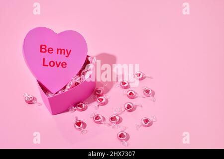 Candies in heart-shaped box Stock Photo