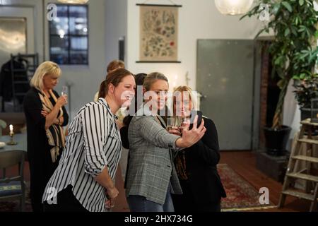 Group of women taking selfie at meeting in cafe Stock Photo