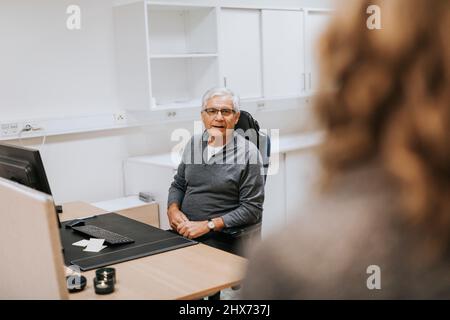 Senior man sitting in office Stock Photo